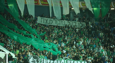אוהדי מכבי חיפה מרימים שלט לזכר נרצחי הפיגוע (עמרי שטיין) אוהדי מכבי חיפה מרימים שלט לזכר נרצחי הפיגוע (עמרי שטיין)